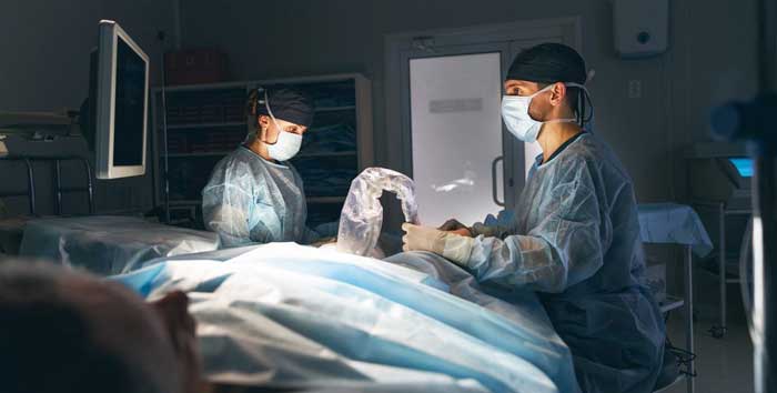 A team of doctors operating on a patient in an emergency room