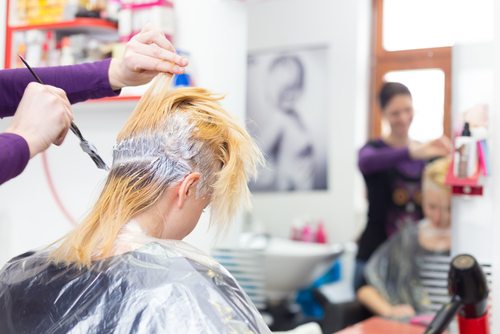 A girl coloring her hairs