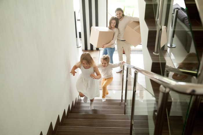 family walking up apartment stairs