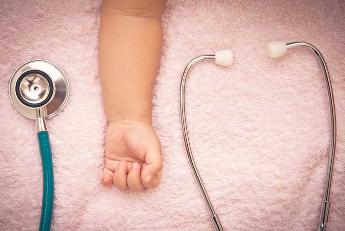 Baby hand with stethoscope
