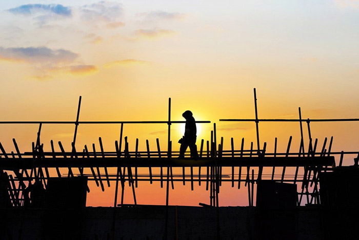 Construction worker walking on the under construction building