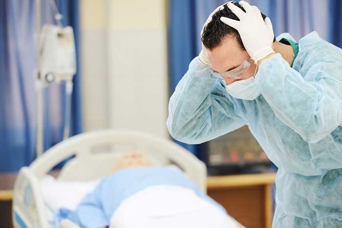 Doctor holding his hand in stress